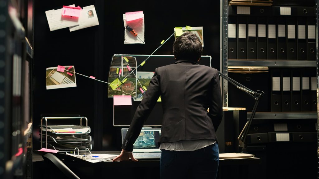 Investigator looking at clues board